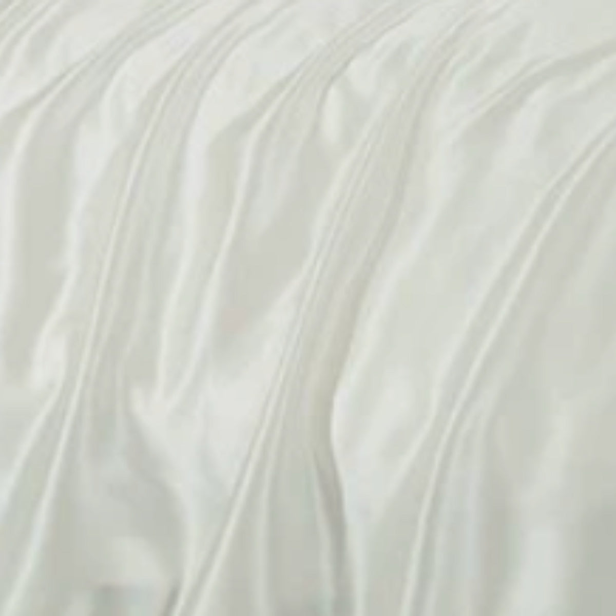 A close-up of draped white fabric with soft folds and a smooth, slightly lustrous texture.