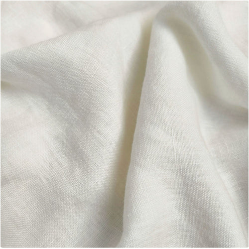 A close-up of draped off-white linen fabric with a visible woven texture and soft folds.