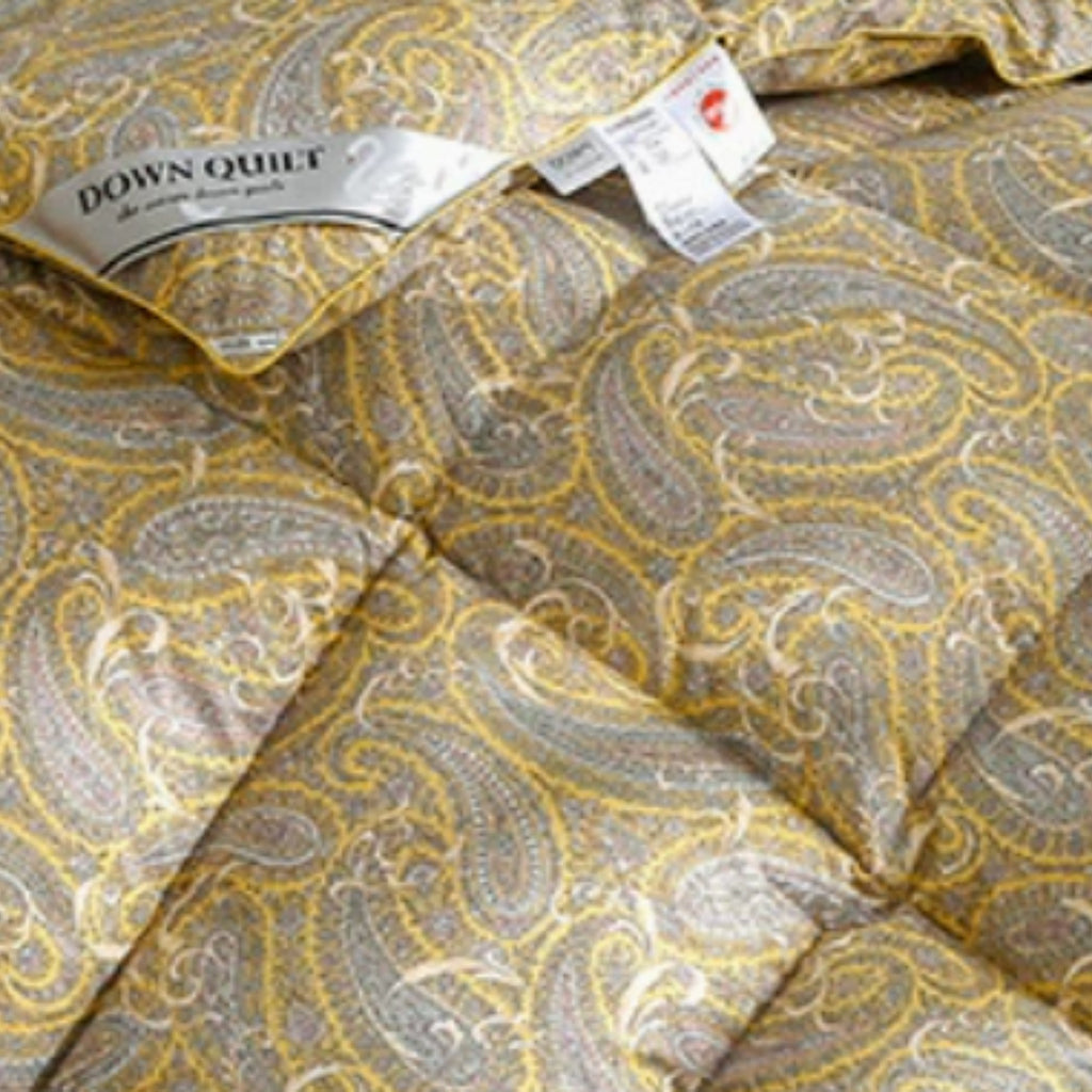 Close-up of a quilted down quilt with a yellow and gray paisley pattern